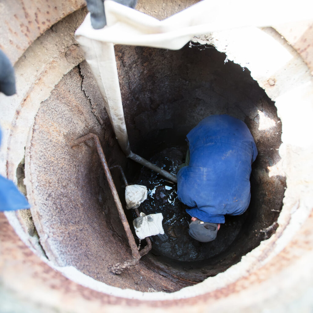 technician cleaning a sewer