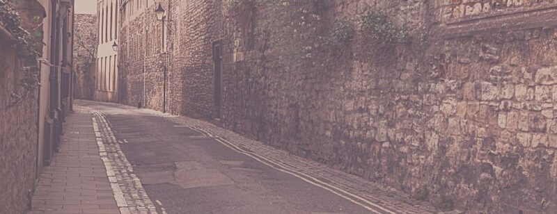 Old cobbled street with Victorian era lamps and architecture