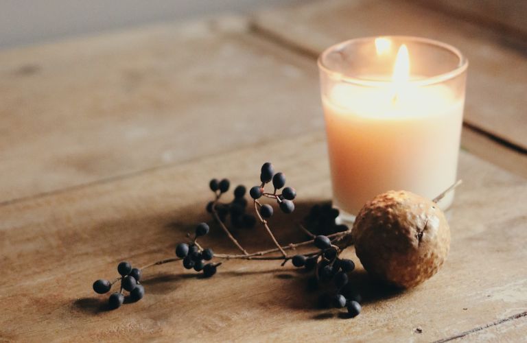 candle and berries on a wooden table scented candle fire and fragrance
