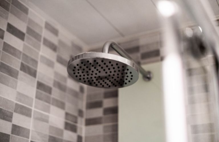 large shower head in modern tiled bathroom shower