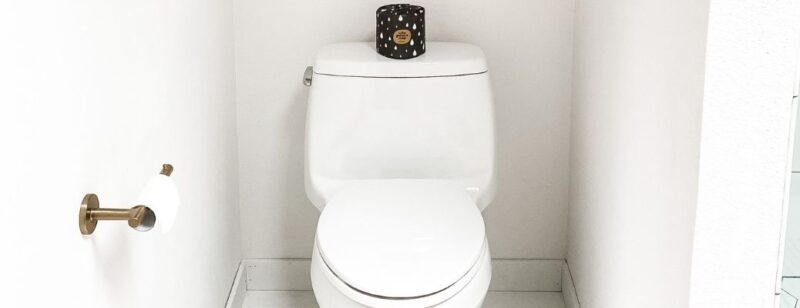 white porcelain toilet in a small white bathroom