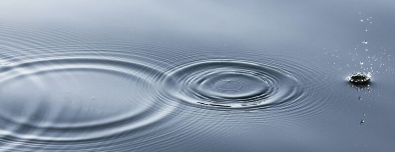 surface of blue water with ripples across the middle