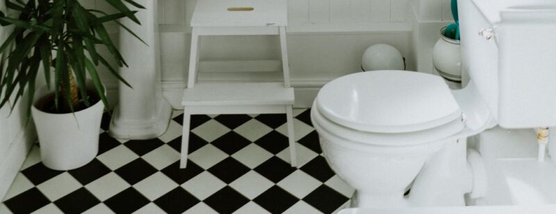 bathroom with a checkered floor and white furniture
