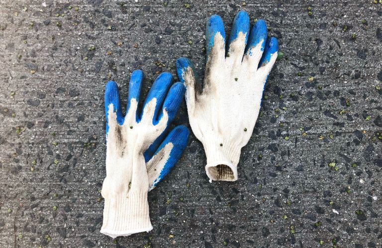 dirty gloves lying on concrete 