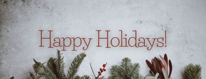 happy holidays text printed over a holiday background with mistletoe and pine branches