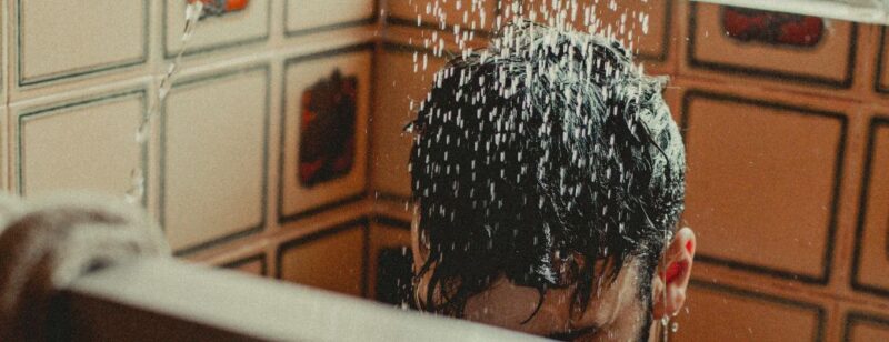 person showering with wet hair