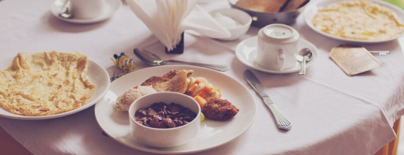 brunch meal set up on white tablecloth