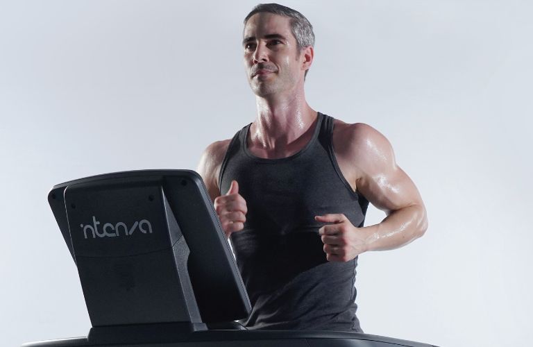 man running on a treadmill looking forward