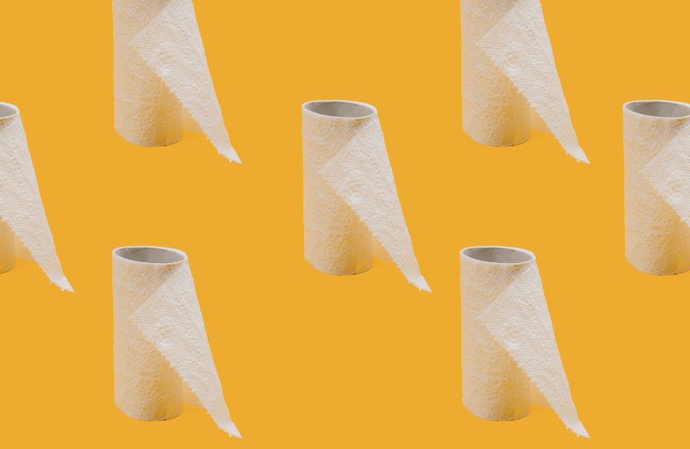 multiple toilet paper rolls nearly empty on a yellow background