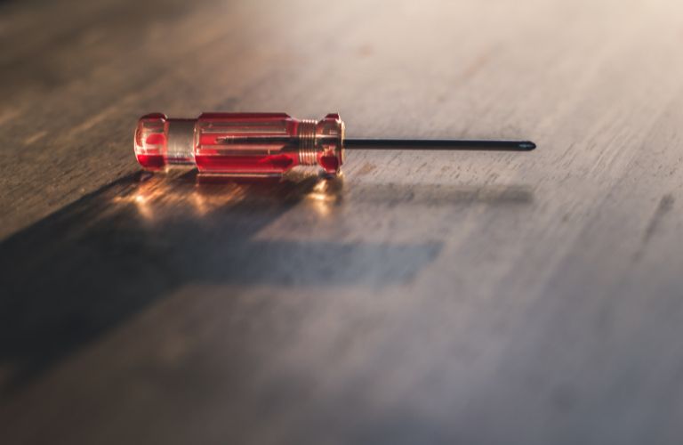 screwdriver sitting on a polished wood table or floor