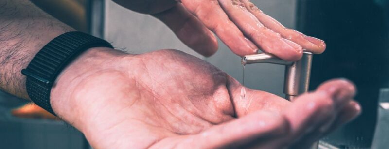 hands using liquid hand soap to wash hands