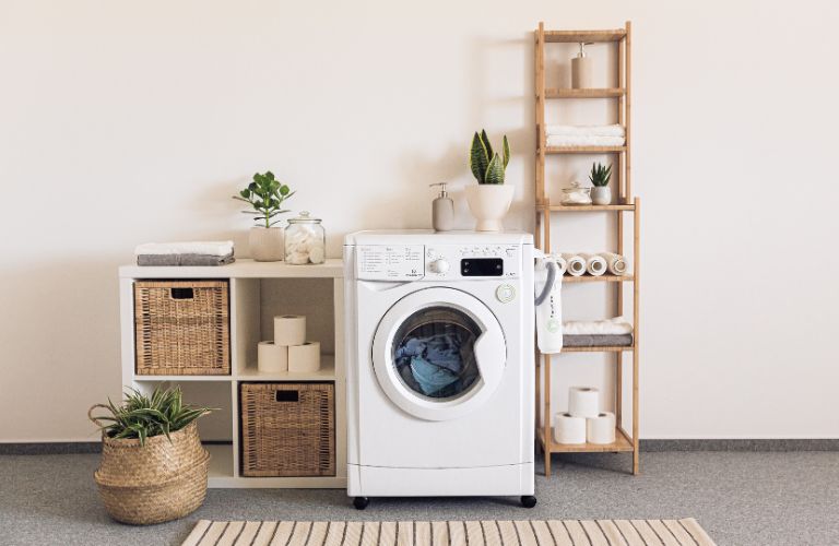 white laundry washing machine with a load in a clean modern home