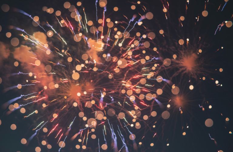 orange blue and red fireworks seen from up close