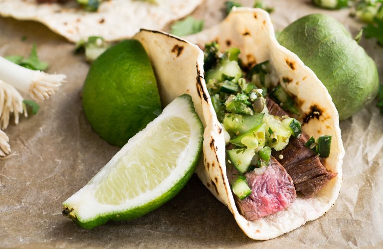 street taco with lime and fresh garnishes
