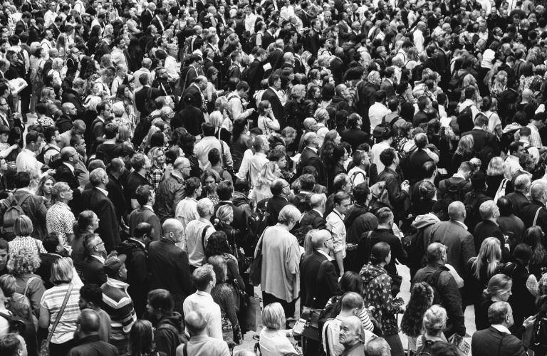 mass of people walking in every direction on the street