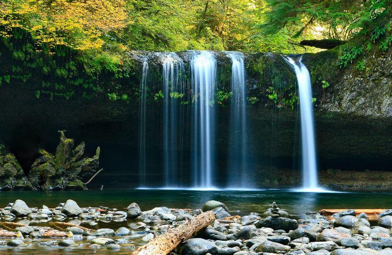 several waterfalls in a row with a rocky shore