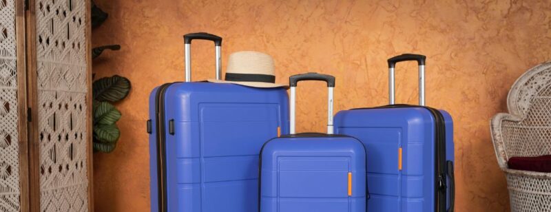 rolling luggage and tourist straw hat prepared for travel