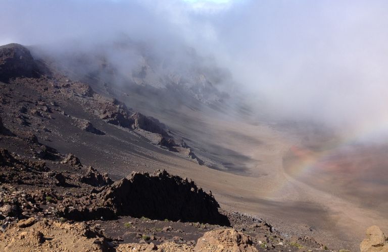 Volcanic crater on Maui Hawaii with a rainbow in the misty air