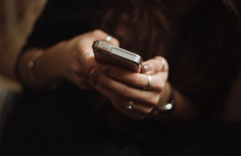 hands holding a cell phone  looking for signal