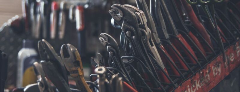 big crate of tools full of wrenches vices and other hand tools