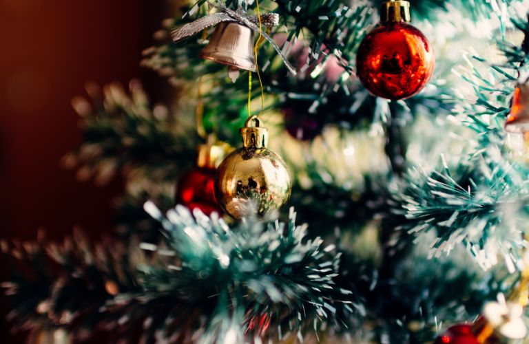 Christmas tree decorated with glass ball ornaments and frosted white